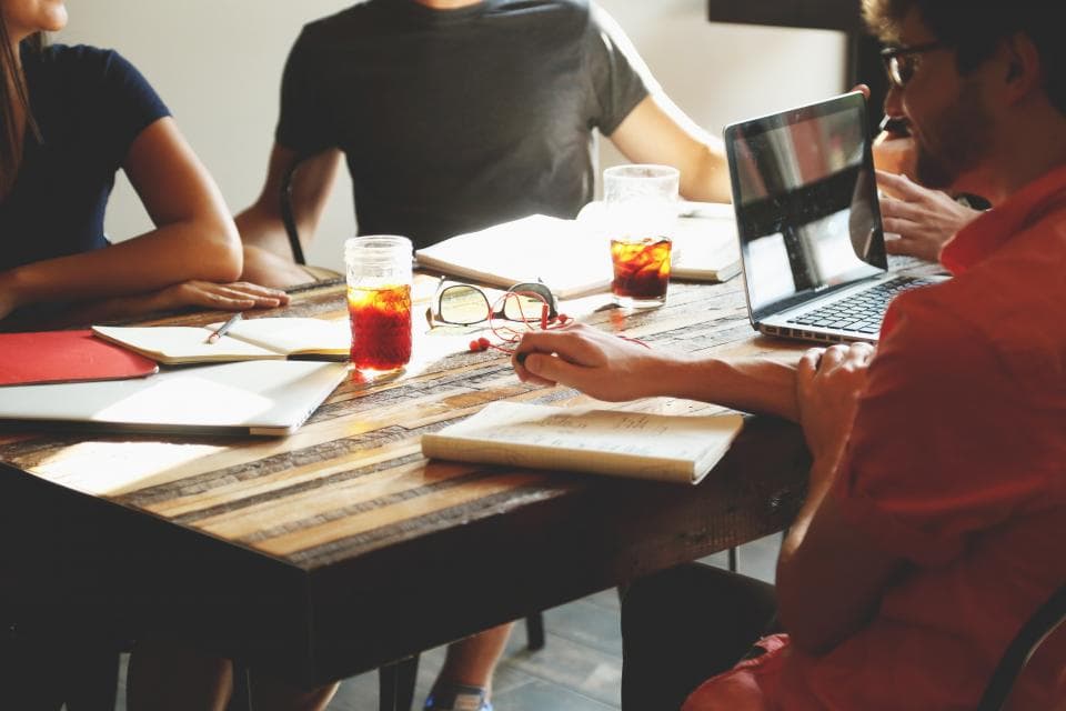 A team talking through a project around a meeting table